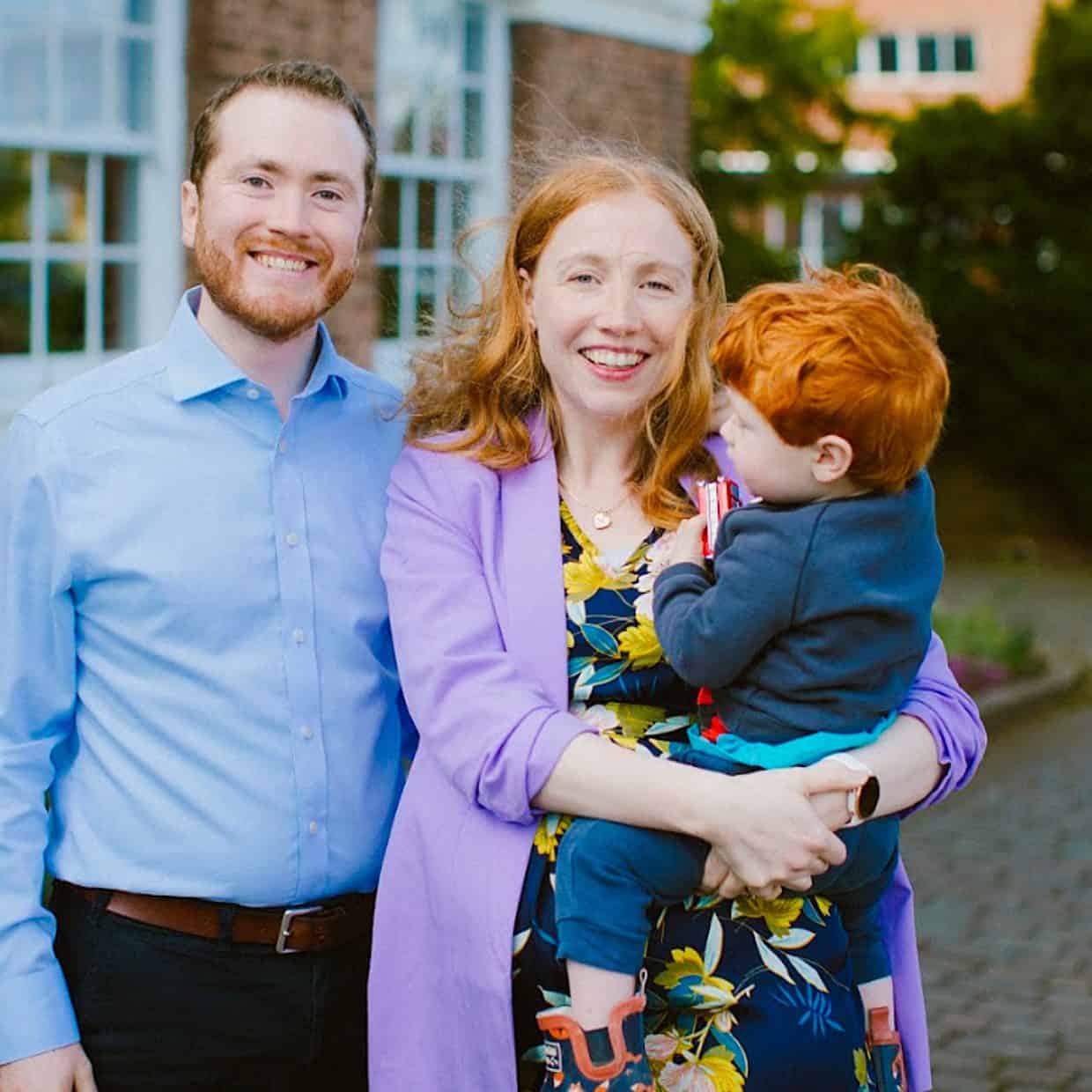 Xander and Melody with their son, standing in front of Redeemer Church, Beeston.